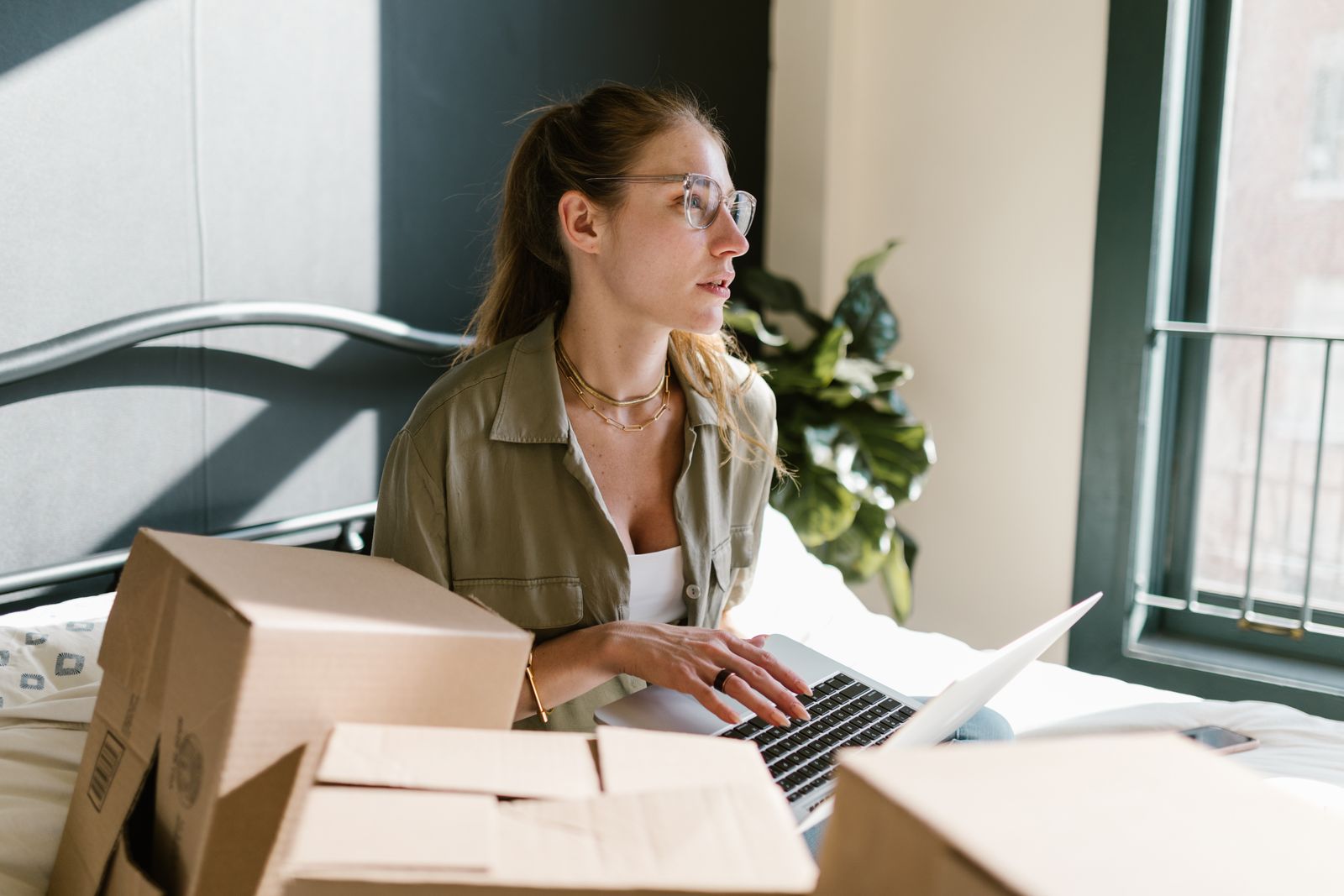 Online business owner working with packages and a laptop